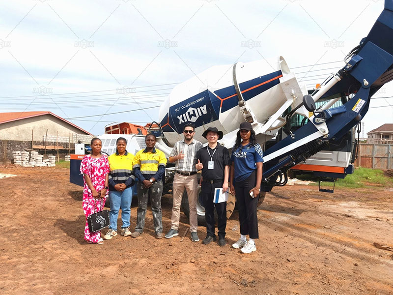 contractors personally operating the self-loading concrete mixer during a live demo, experiencing its capabilities